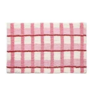 Tapis rose de décoration ou de bain à carreaux avec touche de blanc